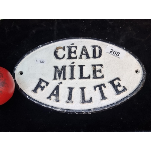 208 - A heavy cast metal wall plaque reading 'Céad Míle Failte'.