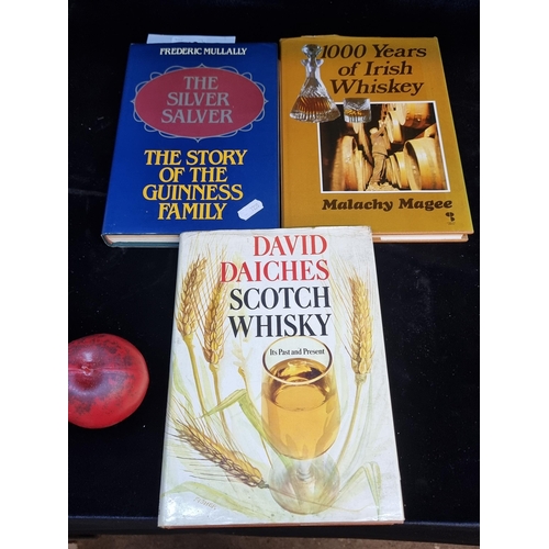 218 - A trio of vintage hardback books including two whisky examples and 'The Story of the Guinness Family... 