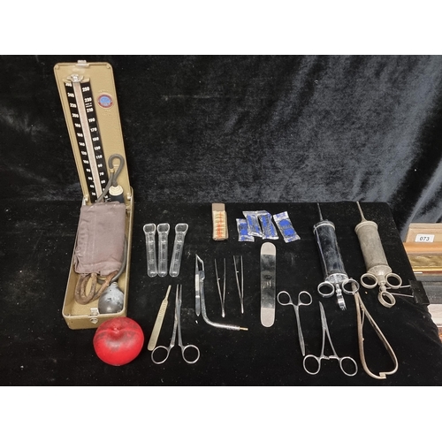 252 - A bag containing a large selection of vintage surgical equipment including syringes and a blood pres... 