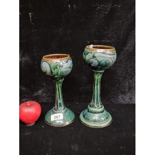 267 - A pair of large striking glazed drinking goblets in vibrant abstract tones of emerald green and coba... 