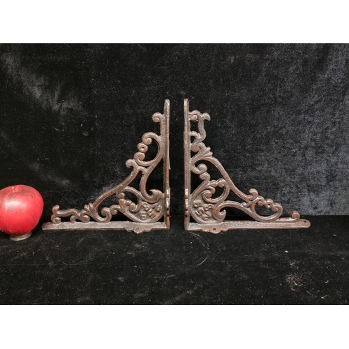 281 - A pair of heavy cast metal wall brackets.