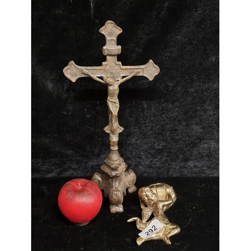 292 - A polished brass holy water wall font with cherub and a cast metal crucifix.