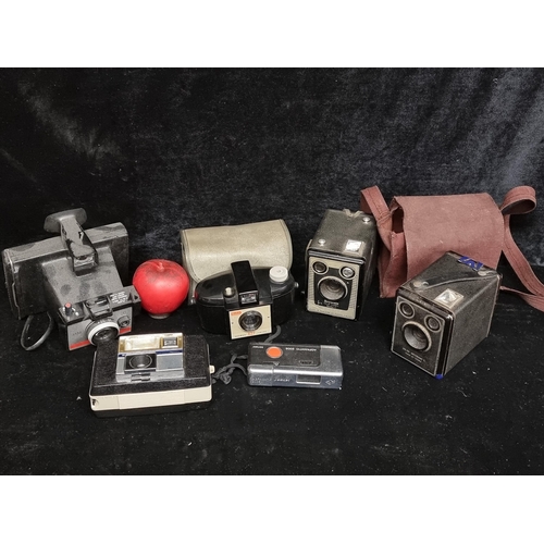 295 - Six vintage cameras including a Koadak Brownie model C, a Polaroid Colorpack 80, and a keystone 725E... 