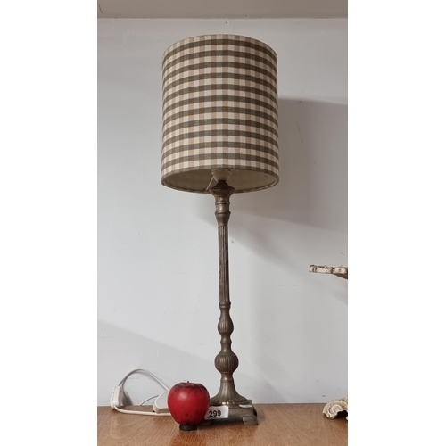 299 - An elegant metal column table lamp with a stylish cylindrical shade.