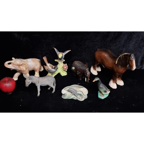 312 - Four ceramic animal figurines including a Carrig ware elephant, a group of garden birds, a runner du... 