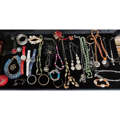 327 - A bag filled with a large number of costume / fashion jewellery including necklaces, bracelets and b... 