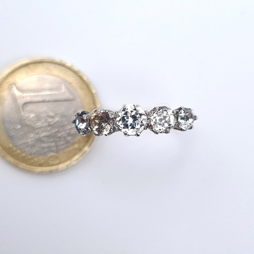 15 - A five stone sparkly zirconia ring marked silver/9K gold stamped to band, size Q, weight 2.34 grams.