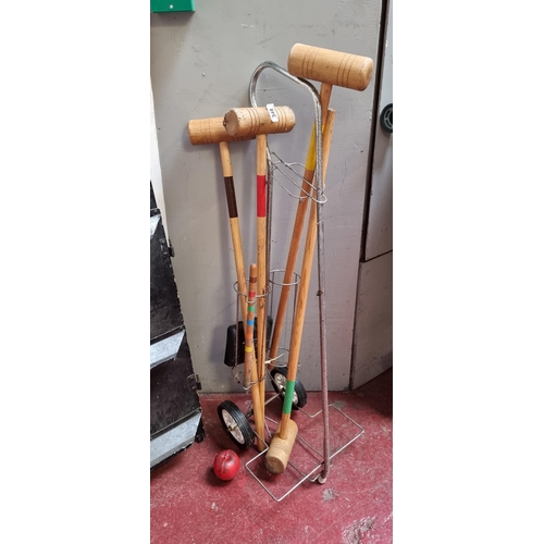 348 - A super vintage part croquet set including four mallets and centre peg. Held in a handy trolly on la... 