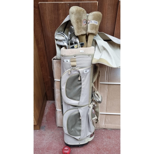 384 - A Ram golf bag holding ten Ram branded golf clubs including irons, putter and three drivers with bra... 