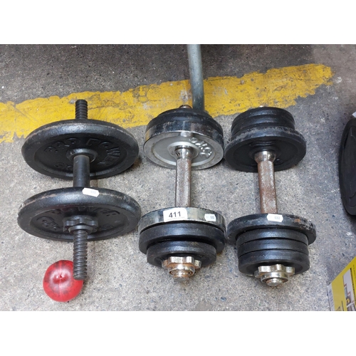 411 - A trio of the dumbbells along with various plate weights.