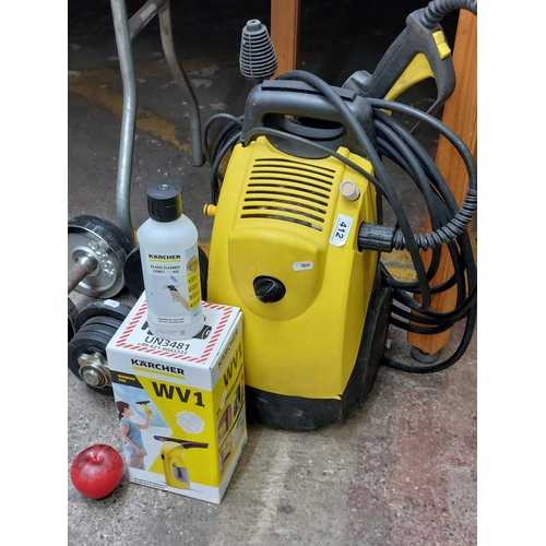 412 - A high quality Karcher pressure washer along with a Karcher window vac and a bottle of solution. Pre... 