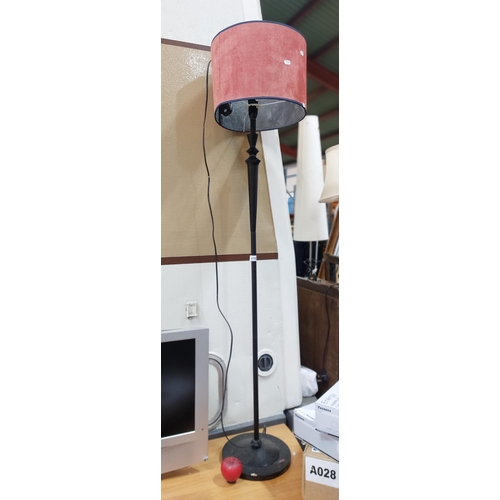 416 - A stylish tall black floor lamp with a red suede shade.