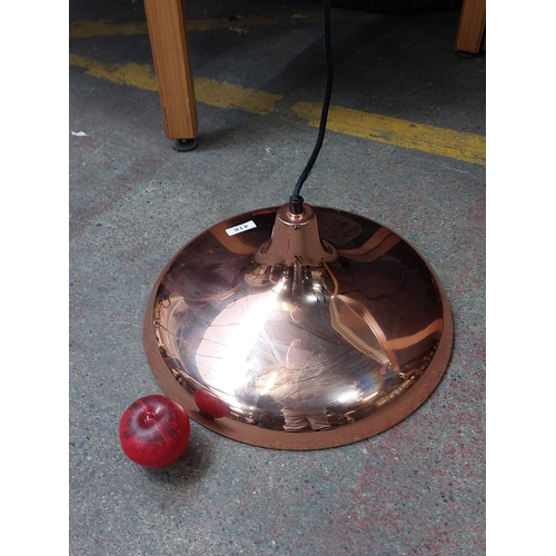 418 - A large as new stylish contemporary enameled celling lamp in a copper finish.