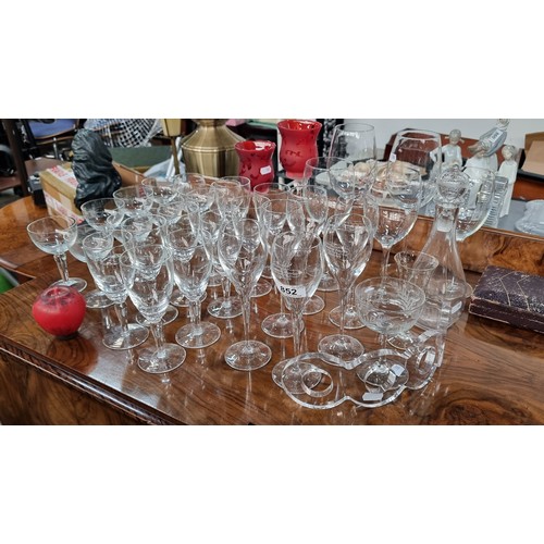 A large selection of drinking glasses. Inc A set of Laurent Perrier champagne glasses.