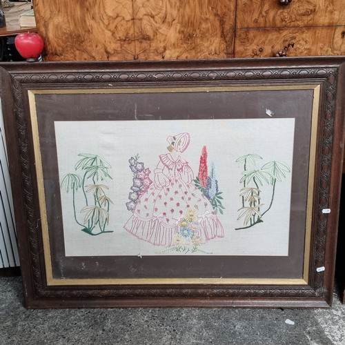 869 - A vintage embroidered panel of a lady in a flared dress in a garden. Info vendor