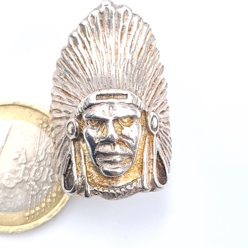 611 - A ring depicting a North American Indian chief, probably silver, size Q, weight 10.9 grams.