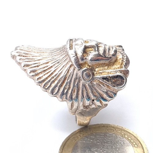 611 - A ring depicting a North American Indian chief, probably silver, size Q, weight 10.9 grams.