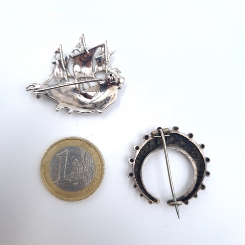 618 - Two brooches including an antique example together with a galleon gem set example , pins intact.