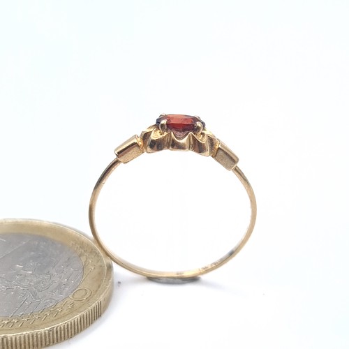 636 - A 9K gold garnet stone ring, size N, weight 0.9 grams, boxed.