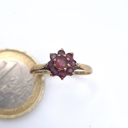 637 - A 9K gold garnet cluster ring, ring size N, weight 1.15 grams.