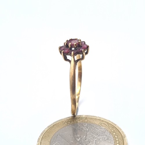 637 - A 9K gold garnet cluster ring, ring size N, weight 1.15 grams.