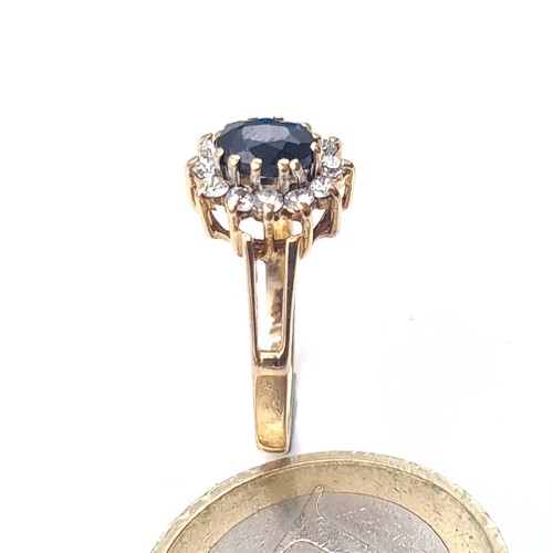 640 - Star Lot : A gem set cluster ring with a sapphire central stone set in 9K gold, size M, weight 1.8 g... 