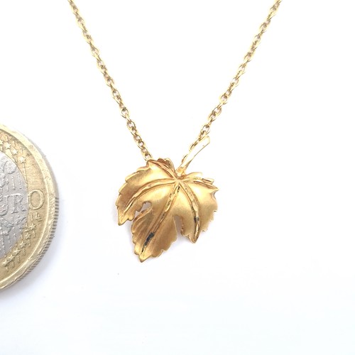 647 - A 9K gold leaf design pendant necklace with chain, length 38cm, weigh 1.95 grams, boxed.