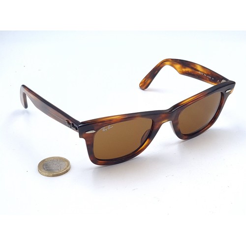 657 - A pair of unused RayBan wayfarer sunglasses with faux tortoise shell frames in original case, togeth... 