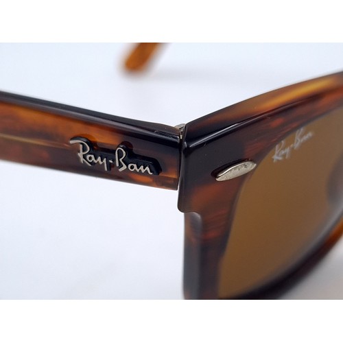 657 - A pair of unused RayBan wayfarer sunglasses with faux tortoise shell frames in original case, togeth... 