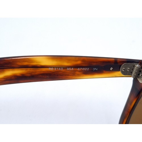 657 - A pair of unused RayBan wayfarer sunglasses with faux tortoise shell frames in original case, togeth... 