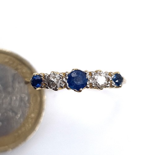 667 - Star Lot : A fine 9K gold five stone diamond and sapphire eternity ring, size O, weight 2.8 grams, b... 