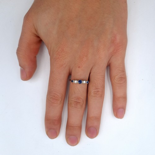 667 - Star Lot : A fine 9K gold five stone diamond and sapphire eternity ring, size O, weight 2.8 grams, b... 