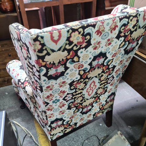 702 - Star Lot : A superb vintage wingback armchair with gorgeous brass stud detailing, upholstered in a v... 