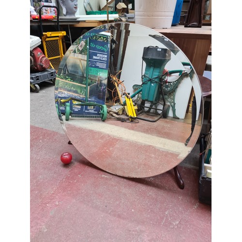 387 - A chic contemporary round beveled wall mirror held in a chrome frame.