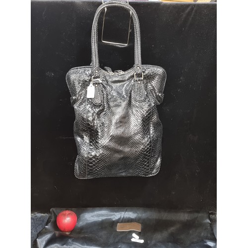 529 - Zagliani’s popular Puffy handbag is made from beautiful black python that is simply accented with go... 