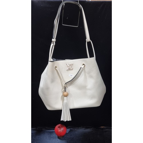 537 - Star Lot : A fabulous original good sized cream leather Louis Vuitton ladies shoulder bag.