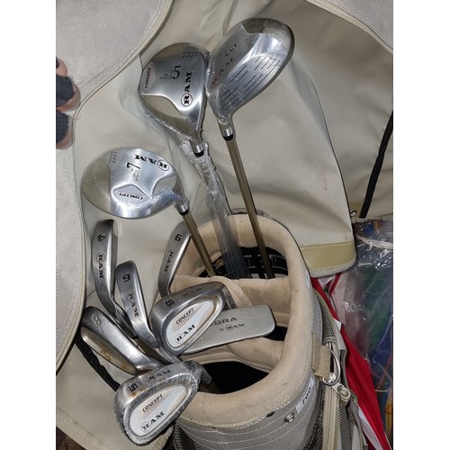 384 - A Ram golf bag holding ten Ram branded golf clubs including irons, putter and three drivers with bra... 