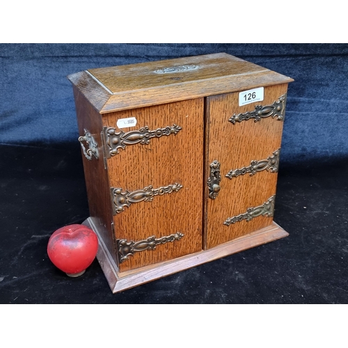 126 - A handsome oak smokers cabinet with lovely ornate hardware and brass hinges.