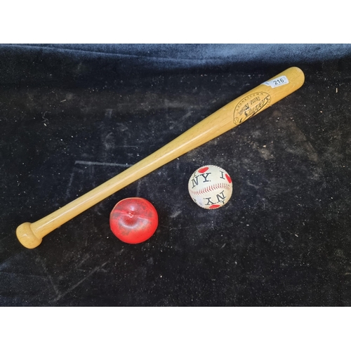 216 - A Looney Tunes Sluggers wooden baseball bat along with a 'I Love New York' baseball.