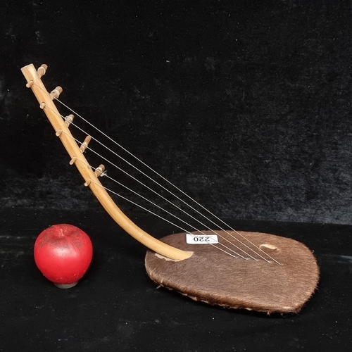 220 - A highly unusual arched harp bow instrument. Instrument style originates from Egypt 3000BC.