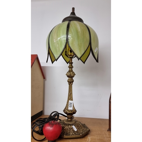 223 - A wonderful brass table lamp featuring scroll detail to base and a very elegant tiffany style shade.... 