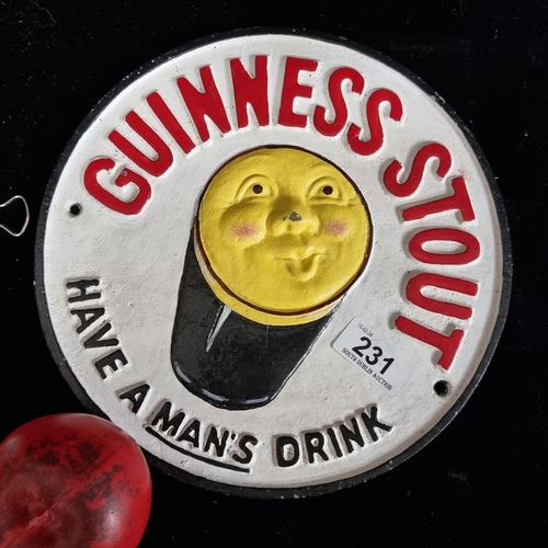 231 - A heavy cast metal circular wall plaque advertising Guinness.