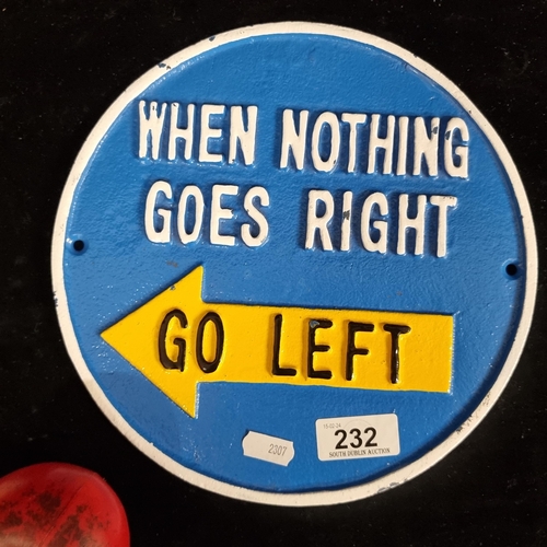 232 - A humorous heavy cast metal wall sign reading 'When nothing goes right, go left'.