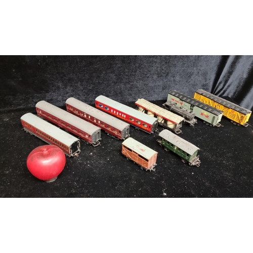 291 - A box containing nine vintage Hornby Tri-ang model train carriages.