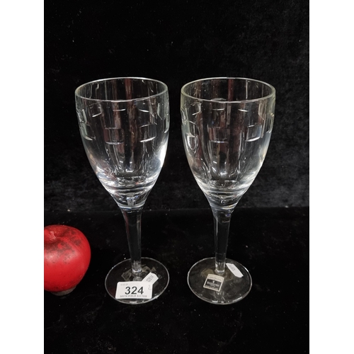 A pair of tall John Rocha for Waterford Crystal wine glasses. In good