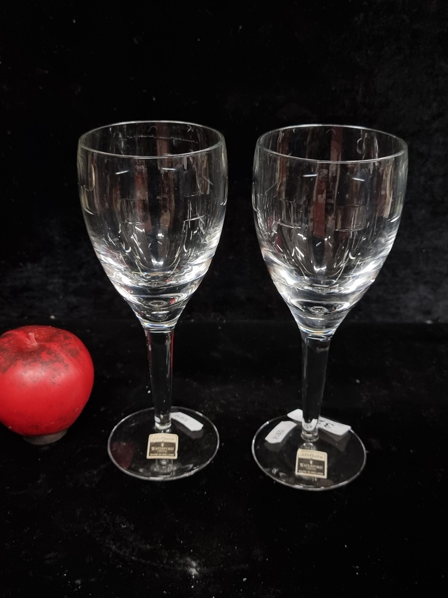 A pair of John Rocha for Waterford Crystal white wine glasses. In good
