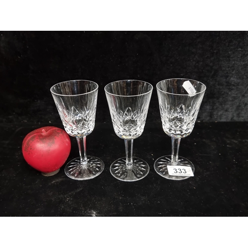3 lovely stemmed Waterford Crystal glasses in the Lismore pattern. In good condition with acid marked base.