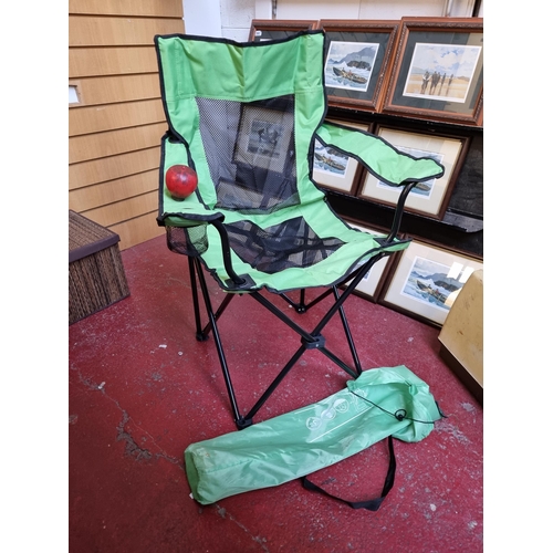 365 - A heavy duty fold up camping deck chair with green canvas seat and built in cup holders. Load capaci... 