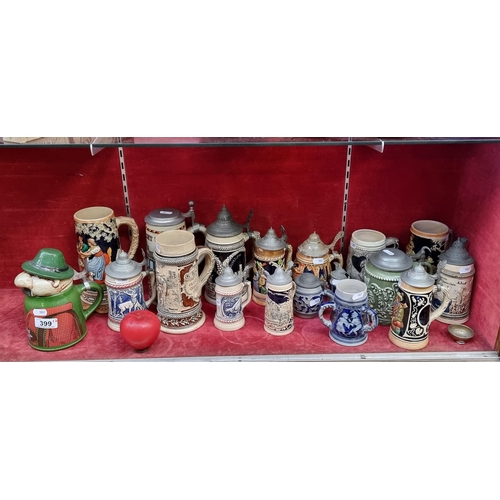 399 - A wonderful collection of 17 beer stein mugs, some vintage West German examples with pewter lids.