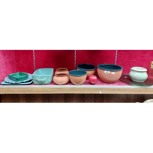 405 - A collection of glazed terracotta kitchenware items. Including bowls, dishes and plates. Also includ... 